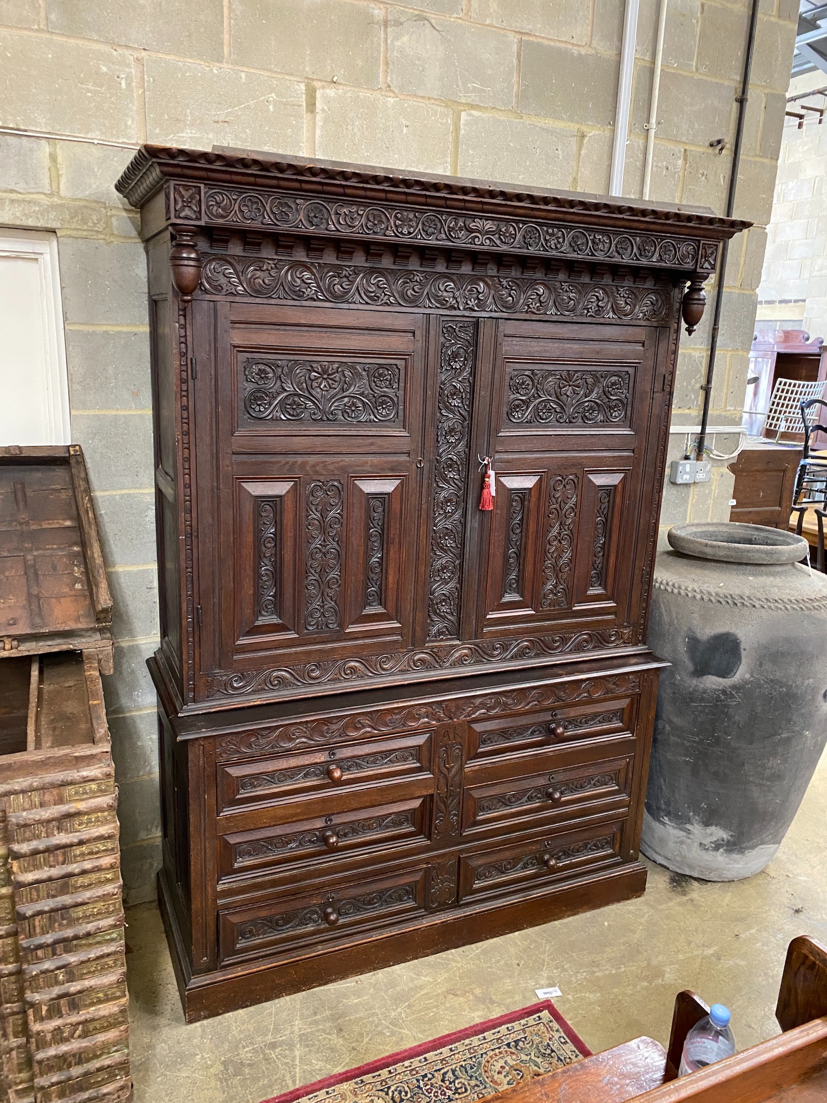A large Flemish oak two part hanging cupboard, length 154cm, depth 55cm, height 219cm